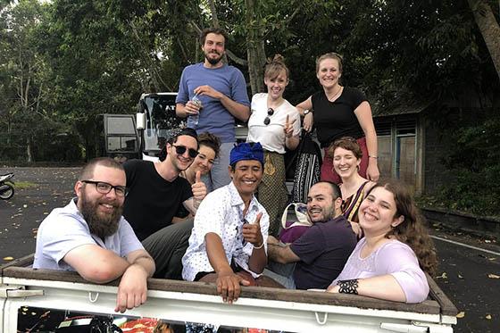Photo of a group of Chatham students seated in a rickshaw vehicle in Indonesia, smiling for a picture