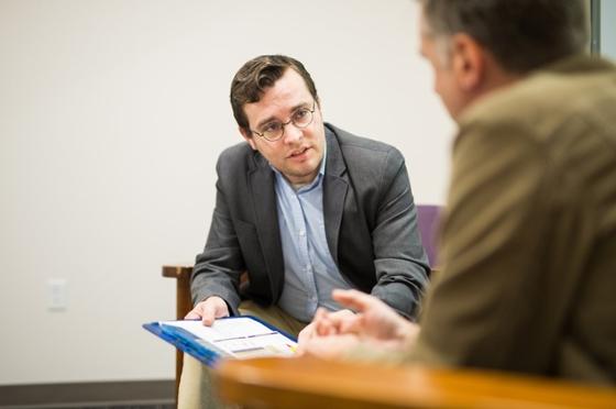 Photo of a Chatham University psychology student speaking with a patient at a counseling session. 
