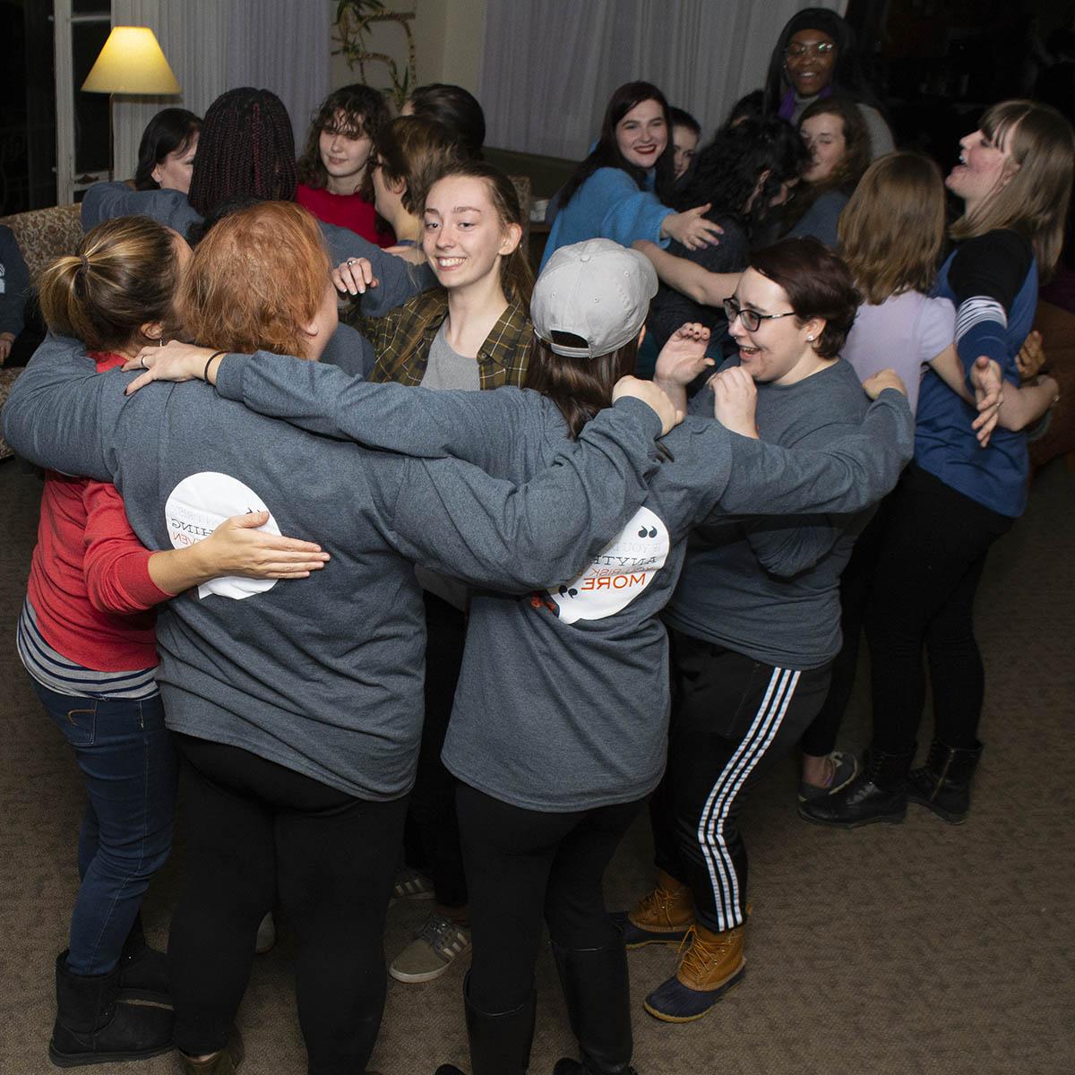 Photo of a group of women smiling in a group hug