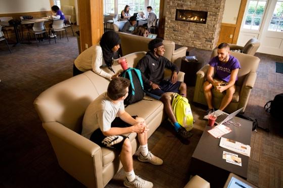 Photo of a group of Chatham University students hanging out in the Carriage House lounge